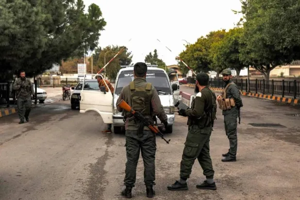 Syrian forces stop a car at a checkpoint after taking control of the port of Tartus earlier this month. (AFP) 