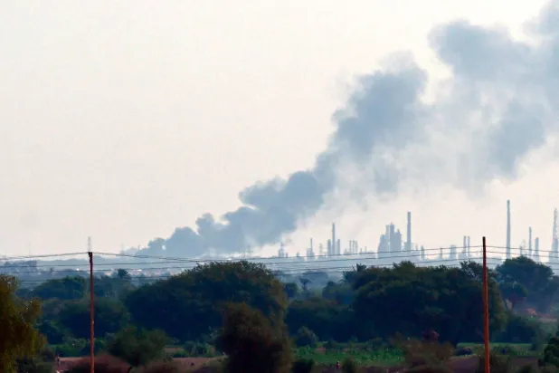 Smoke billows from al-Jaili oil refinery north of Omdurman, the Sudanese capital's twin city, during battles between the Sudanese military forces and paramilitary Rapid Support Forces (RSF), on January 15, 2025. (Photo by AFP)
