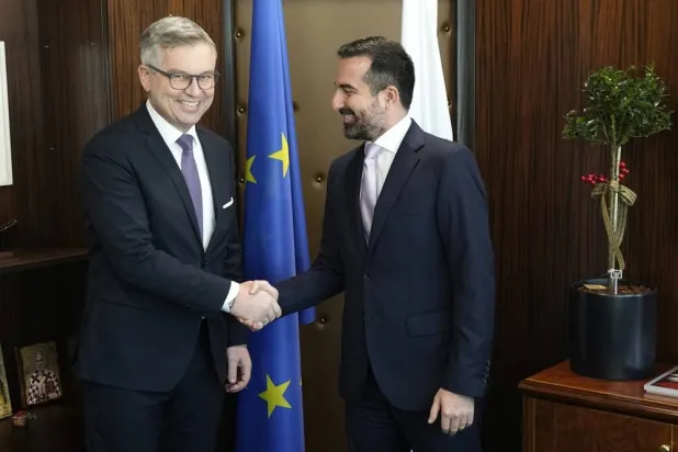 Cyprus' deputy Minister of Migration and International Protection Nicholas Ioannides, right, and the EU Commissioner for Internal Affairs and Migration Magnus Brunner shake hands before their meeting at the Deputy Ministry of Migration and International Protection in capital Nicosia, Cyprus, Friday, Jan. 17, 2025. (AP) 