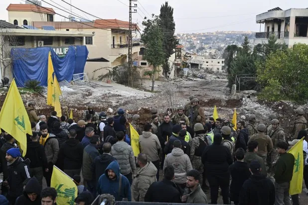 People gather in front of army soldiers after being barred from returning to the village of Aitaroun, Bint Jbeil District, southern Lebanon, 27 January 2025. (EPA) 