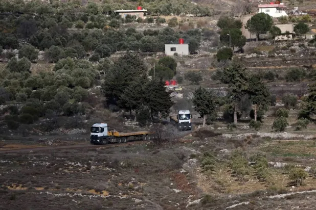Israeli trucks cut off a buffer zone between Syria and Israel at the town of Majdal Shams in the occupied Golan Heights (EPA) 