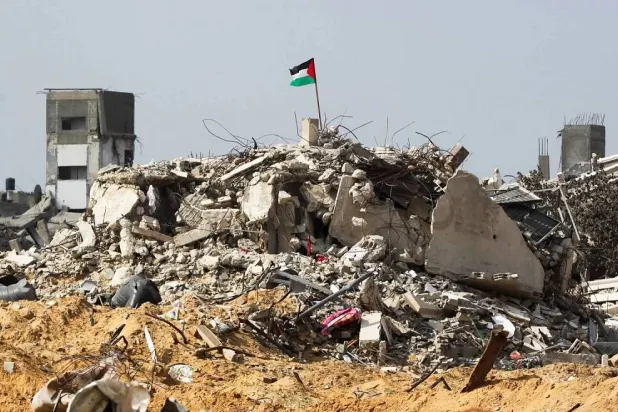 A Palestinian flag over the rubble of a destroyed building in Rafah, Gaza., on Tuesday. (Reuters) 