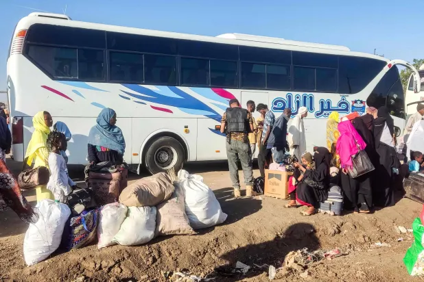 People displaced by the ongoing war in Sudan prepare to board buses taking them home to their city of Wad Madani in the Jazira state after it was retaken by the Sudanese army from the Rapid Support Forces (RSF), in the eastern city of Gedaref on February 3, 2025. (Photo by AFP)