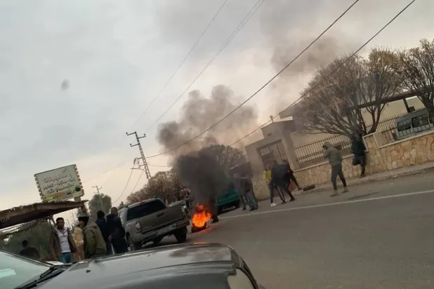 Residents of the town of Hermel’s al-Shawagher burn tires along the road leading to Syria. 