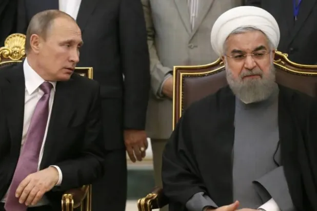 Russian President Vladimir Putin speaks with former Iranian President Hassan Rouhani during their talks after the third Gas Exporting Countries Forum summit in Tehran, November 23, 2015 (File - Getty)