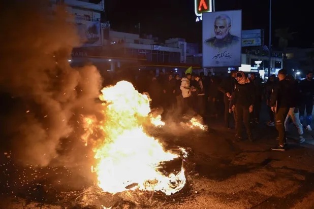Supporters of Hezbollah burn tires during a protest in front of the entrance to Rafik Hariri International Airport in Beirut, Lebanon, 13 February 2025. (EPA) 