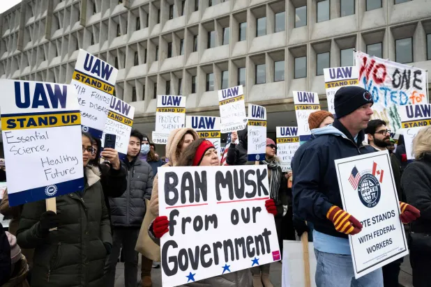 متظاهرون يحتجون ضد سياسات الرئيس الأميركي دونالد ترمب وإيلون ماسك خارج مقر وزارة الصحة والخدمات الإنسانية في العاصمة الأميركية واشنطن 19 فبراير 2025 (أ.ف.ب)