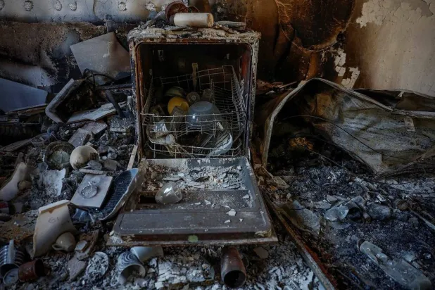 The destroyed contents of a dishwasher and household goods are seen at a home at Kibbutz Nir Oz following the October 7, 2023, Hamas attack. (Reuters) 