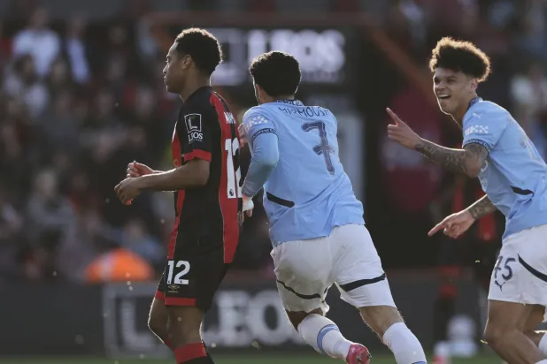 Manchester City's Omar Marmoush, center, celebrates with Manchester City's Nico O'Reilly, right, after scoring his side's second goal during the English FA Cup quarterfinal soccer match between Bournemouth and Manchester City at the Vitality stadium in Bournemouth, England, Sunday, March 30, 2025. (AP Photo/Ian Walton)