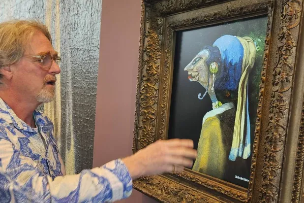Rob de Heer talks next to his artwork, one of 60 pieces exhibited and inspired by the famous "Girl with a Pearl Earring," painting by Johannes Vermeer, at The Mauritshuis museum in The Hague, Netherlands, Tuesday, March 25, 2025. (AP) 