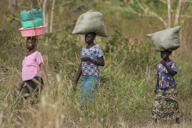 Women walk to the market near Nzara, South Sudan on Saturday, Feb. 15, 2025. (AP Photo/Brian Inganga)