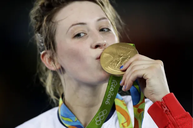 FILE - Jade Jones, of Britain, kisses her gold medal in women's 57-kg taekwondo at the 2016 Summer Olympics in Rio de Janeiro, Brazil, Thursday, Aug. 18, 2016. (AP Photo/Robert F. Bukaty, File)
