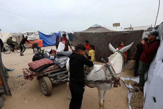 عائلة محمد شيخ أمام خيمتهم في مخيم المواصي بخان يونس (الشرق الأوسط)
