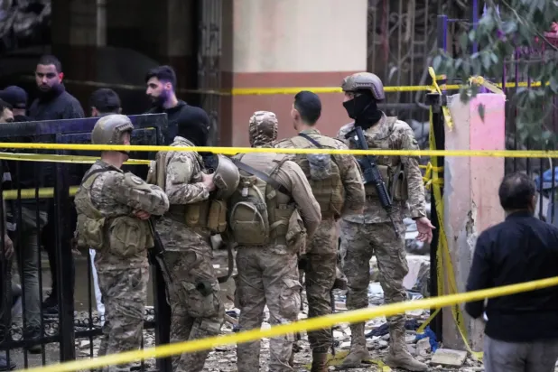 جنود من الجيش اللبناني يطوقون منطقة استهدفتها غارة إسرائيلية في ضاحية بيروت الجنوبية (أ.ب)