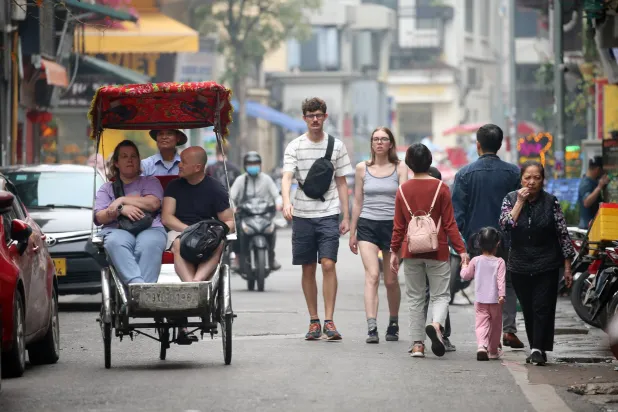 سياح يجولون في أحد شوارع هانوي (إ.ب.أ)