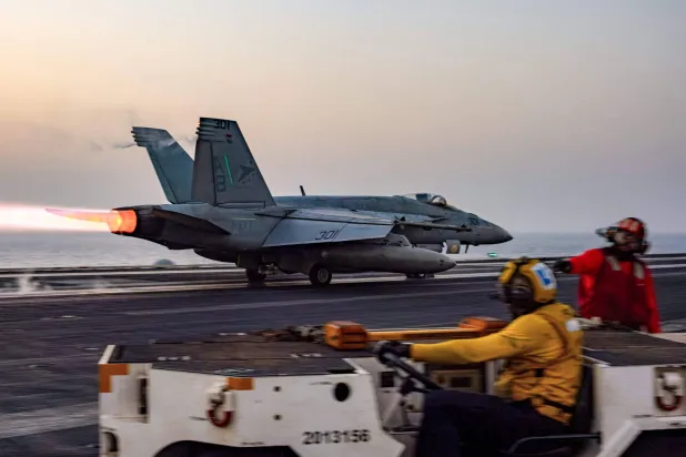 This handout photo released by the US Defense Visual Information Distribution Service (DVIDS) shows a US F/A-18 Super Hornet attack fighter jet taking off from the US Navy's Nimitz-class USS Harry S. Truman aircraft carrier at sea on March 16, 2025. (Photo by Hunter DAY / DVIDS / AFP)