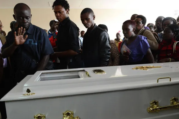 رجل يُشير بيده وهو ينظر إلى جثمان أنجيلا نيوكابي التي قُتلت خلال الهجوم على جامعة غاريسا في مشرحة جامعة كينياتا في نيروبي في 10 أبريل 2015 (أ.ف.ب )