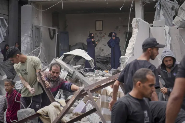 Palestinians search the rubble of a house targeted by an Israeli army strike in Khan Younis, in the southern Gaza Strip, Thursday, May 1, 2025. (AP Photo/Abdel Kareem Hana)