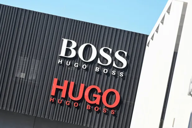 FILED - 08 March 2022, Baden-Wuerttemberg, Metzingen: The logo of the Hugo Boss fashion group, is seen at an outlet store at the company headquarters in Metzingen. Photo: dpa