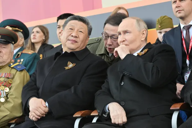 الرئيس الروسي فلاديمير بوتين ونظيره الصيني شي جينبينغ يحضران عرضاً عسكرياً في يوم النصر، إحياءً للذكرى الثمانين للانتصار على ألمانيا النازية في الحرب العالمية الثانية، في الساحة الحمراء، وسط موسكو، روسيا 9 مايو 2025 (رويترز)