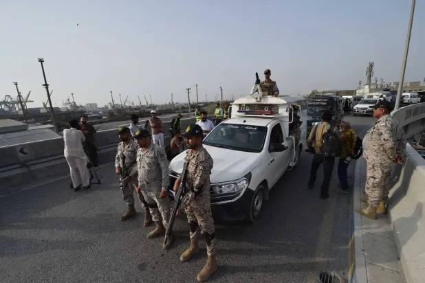 مسؤولون أمنيون باكستانيون في ميناء كراتشي بعد التصعيد العسكري بين إسلام آباد ونيودلهي (إ.ب.أ)  