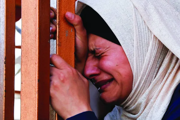 
فلسطينية تبكي أقارب لها قُتلوا بغارات إسرائيلية في خان يونس جنوب قطاع غزة أمس (رويترز)