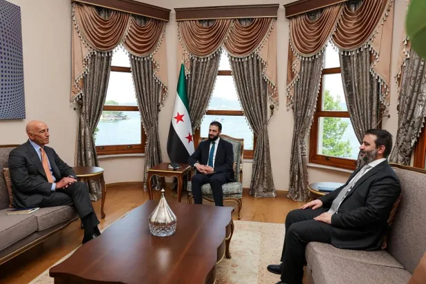 A handout photo made available by the Turkish Foreign Ministry Press Office shows Syrian President Ahmed al-Sharaa (C) and Thomas J. Barrack of the US Embassy in Türkiye (L) during their meeting in Istanbul, Türkiye, 24 May 2025. (EPA/ Turkish Foreign Ministry Press Office Handout) 