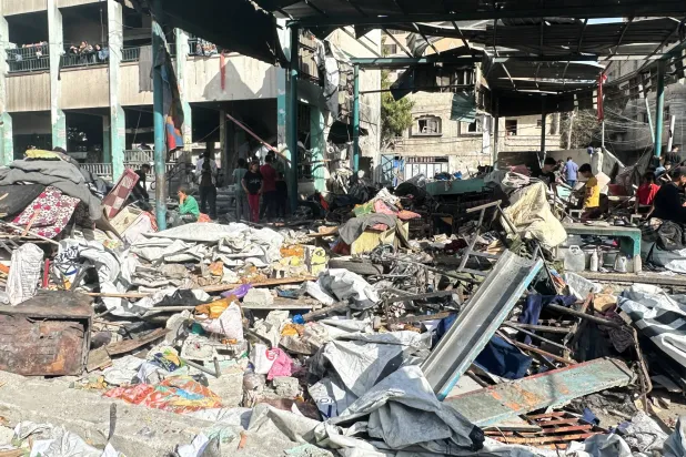 26 May 2025, Palestinian Territories, Gaza: Local residents survey the profound devastation inflicted upon the Fahmi Al-Jarjawi School by relentless Israeli airstrikes. Photo: Khasan Alzaanin/TASS via ZUMA Press/dpa