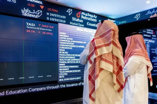People monitoring the performance of the Saudi stock market (Bloomberg) 