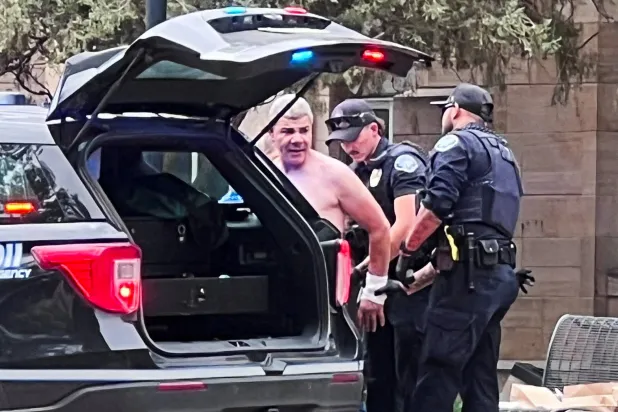 صورة متداولة عبر وسائل التواصل الاجتماعي تظهر رجال الشرطة وهم يلقون القبض على منفذ الهجوم محمد صبري سليمان الأحد (رويترز)