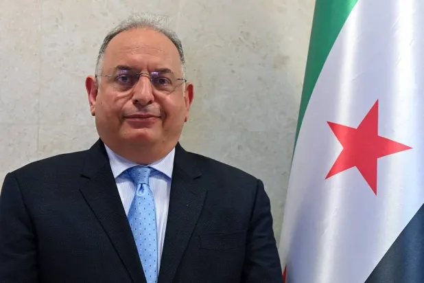 Syrian Minister of Finance Mohammed Yisr Barnieh poses for a picture ahead of the opening of the stock market in the Yafur area near Damascus on June 2, 2025. (AFP) 