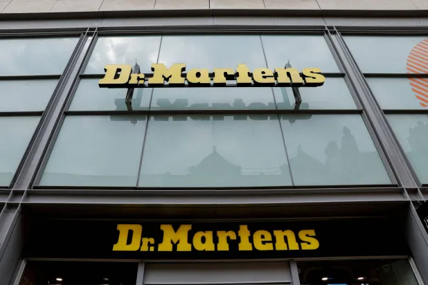 FILE PHOTO: Dr. Martens logos are pictured in Manchester, Britain, May 26, 2023. REUTERS/Jason Cairnduff/File Photo