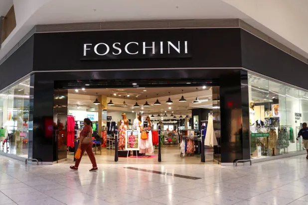 FILE PHOTO: A shopper walks past a Foschini store (owned by TFG) at a shopping center in Johannesburg, South Africa, November 11, 2022. REUTERS/Siphiwe Sibeko/File Photo