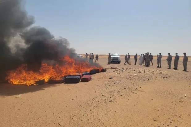 Officials oversee the destruction of narcotics seized during drug busts on the Yemeni-Saudi border. (Saba) 