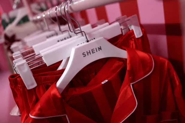 FILE PHOTO: A company logo for fashion brand Shein is seen on a rail of clothing on its Christmas bus as part of a nationwide promotional tour in Liverpool, Britain, December 14, 2024. REUTERS/Phil Noble/File Photo