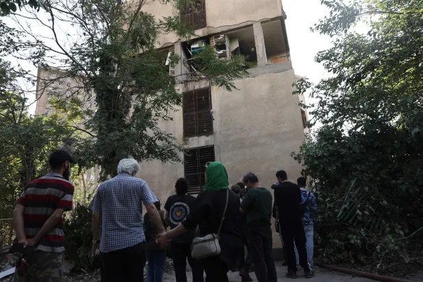 People gather near a damaged building, in the aftermath of Israeli strikes, in Tehran, Iran, June 13, 2025. Majid Asgaripour/WANA (West Asia News Agency) via REUTERS