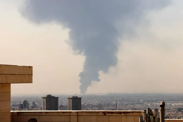 A thick column of smoke rises above an oil refinery south of Tehran after it was targeted in an overnight Israeli airstrike (AFP). 