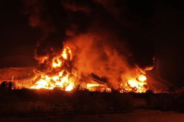 Flames rise from an oil storage facility after it appeared to have been hit by an Israeli strike in Tehran, Iran, early Sunday, June 15, 2025. (AP)