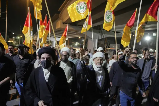 Iraklı şeyhler salı günü Bağdat'ta Irak Büyükelçiliğinin bulunduğu Yeşil Bölge'ye giden yolda İran'la dayanışma gösterisine katıldı (AP)