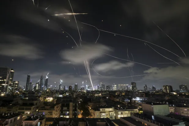 The Israeli Iron Dome air defense system fires to intercept missiles during an Iranian attack over Tel Aviv, Israel, early Wednesday, June 18, 2025. (AP Photo/Leo Correa)