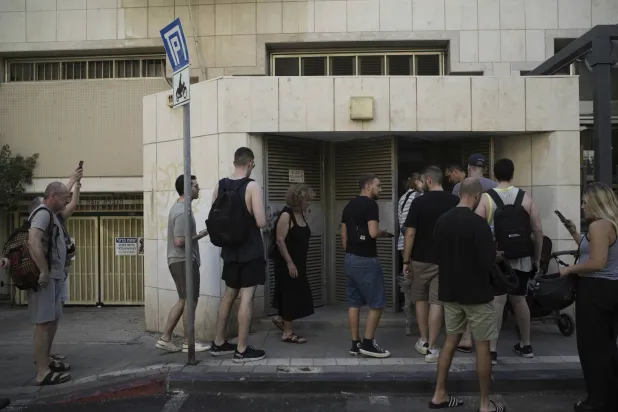 إسرائيليون يدخلون ملجأ في تل أبيب بعد دوي صفارات الإنذار للتحذير من صواريخ إيرانية (أ.ب)