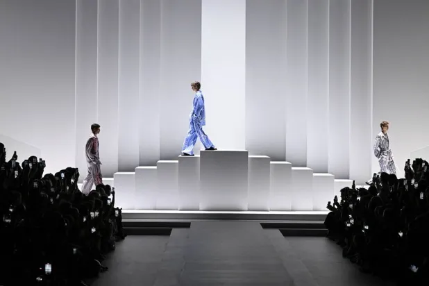 Models acknowledge the audience at the end of the presentation of creations by Dolce & Gabbana for the Menswear Ready-to-wear Spring-Summer 2026 collection as part of the Milan Fashion Week, in Milan on June 21, 2025. (AFP)