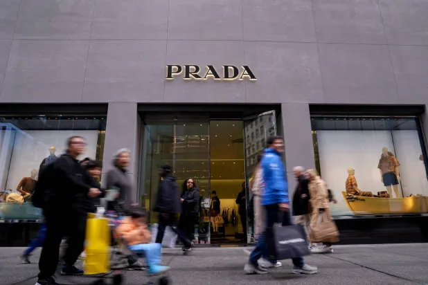 FILE PHOTO: People walk past the store of Italian luxury fashion house Prada on 5th Avenue in New York City, US, May 23, 2025. REUTERS/Adam Gray/File Photo