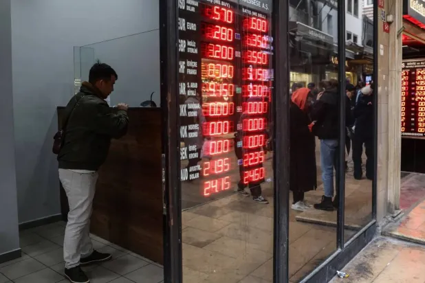 مواطن يغيِّر عملات من مكتب صرافة في أنقرة (د.ب.أ)