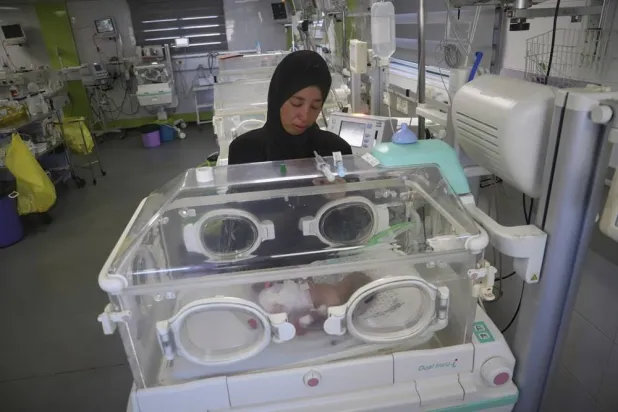  Seham Fawzy Khodeir watches her son, Hisham, who is just days old and was born prematurely, lying in an incubator at the neonatal intensive care unit of Nasser Hospital in Khan Younis, southern Gaza Strip, Thursday, June 19, 2025. (AP) 