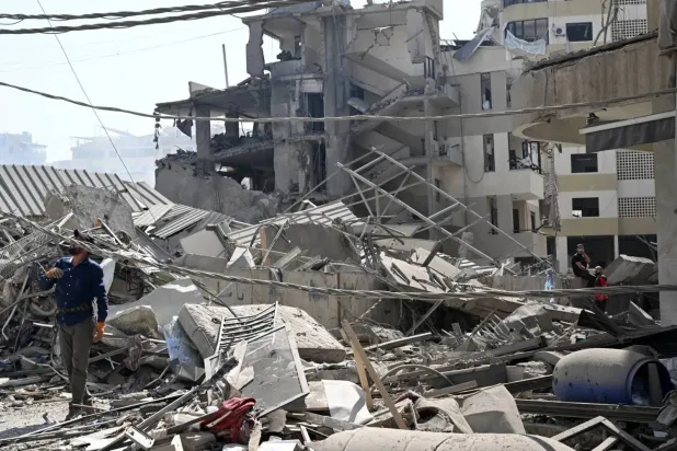 A man surveys the damage caused by Israeli airstrikes on the southern suburbs last week. (EPA)