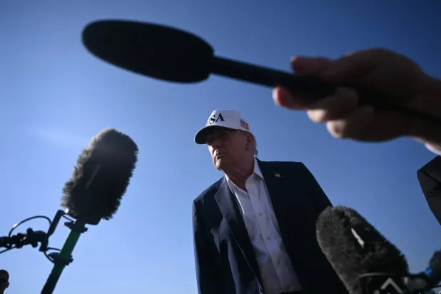 ABD Başkanı Donald Trump, Air Force One uçağına binmeden önce gazetecilere konuşuyor (AFP)