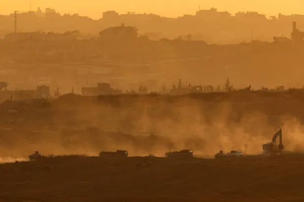This picture taken from a position at Israel's border with the Gaza Strip shows Israeli army vehicles driving in the besieged Palestinian territory on July 8, 2025. (Photo by Jack GUEZ / AFP)