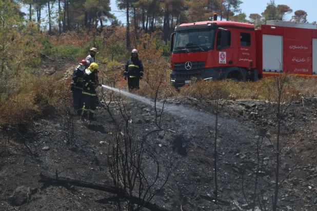 عمليات التبريد لمواقع الحرائق التي تمت السيطرة عليها في جبل التركمان بريف اللاذقية (الدفاع المدني السوري)