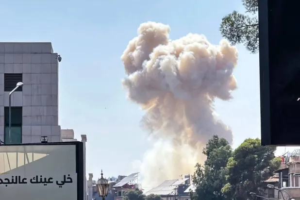 Smoke rises near the headquarters of the Syrian Ministry of Defense following an Israeli strike on Wednesday. (AFP) 